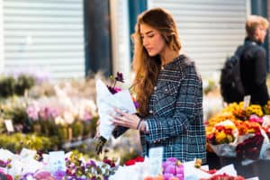 Woman purchasing a bouquet of flowers