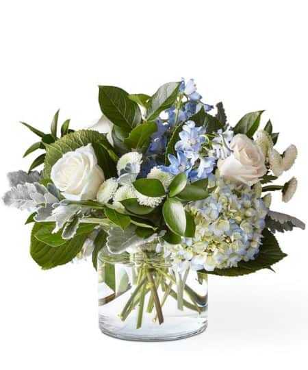 Let this uplifting arrangement be a reminder of the clear skies ahead. Reminiscent of the hope that a new day brings, this bouquet is composed of voluminous hydrangea blooms and vibrant belladonna delphinium to refresh their mood.