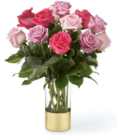 For whatever you're trying to say, say it with roses. Our Pure Beauty rose bouquet is full of the timeless bloom in sweetest shades of lavender and assorted pinks. It sits pretty in a clear glass vase with a metallic gold base to delight their day! Please note that the Classic version includes one dozen roses. The Deluxe version includes 24 roses.
